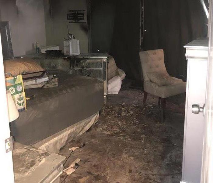 Fire damage inside bedroom caused by candle