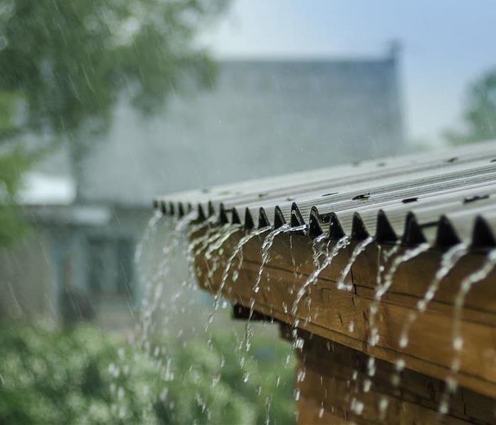 Picture of rain water falling off roof