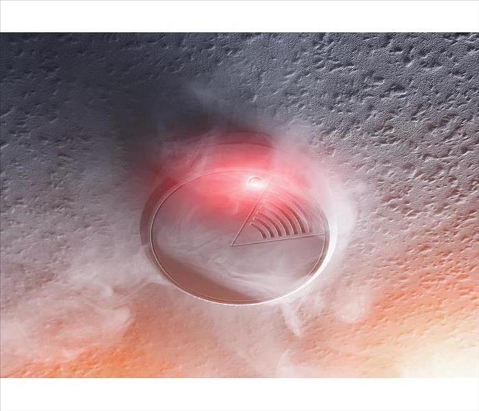 smoke detector with white smoke and red warning light