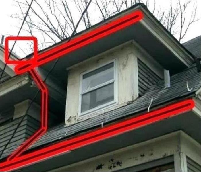A home with the gutter area marked in red lines.